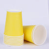 A stack of yellow and white disposable cups, including a single cup, for parties and events.