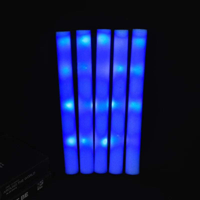 A row of six bright blue glowing foam sticks against a black background.