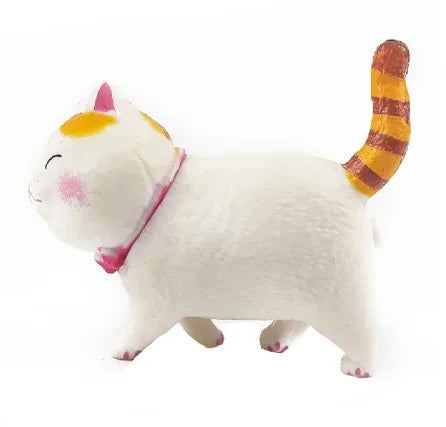 A white and orange striped cartoon cat figurine with a pink collar.