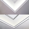 A close-up view of white self-adhesive PVC wall trim tape installed in a chevron pattern on a gray wall.