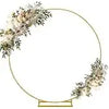 A gold-rimmed circular frame decorated with white floral greenery, suitable for displaying vintage bud glass vases.