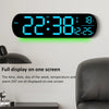 Reloj de pared digital negro que muestra la hora 22:38, miércoles, temperatura 18°C e información de horario de verano.