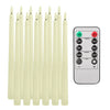 A set of cream-colored flameless LED taper candles and a remote control with timer and light settings.