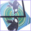 A vibrant mosaic artwork featuring a deer silhouette in shades of blue, green, and gold sequins on a square display frame.