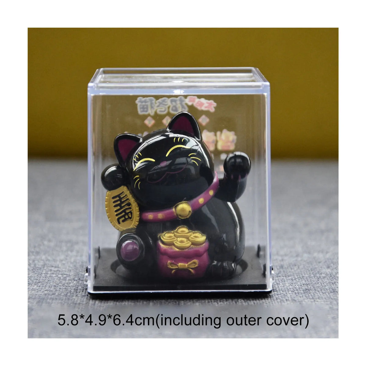 A black solar-powered waving lucky cat figurine displayed inside a clear box.