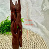 A dark brown wooden tripod stand for displaying an abalone shell or crystal ball.