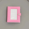 A pink mini photo card binder with a clear plastic cover and a silver clasp.