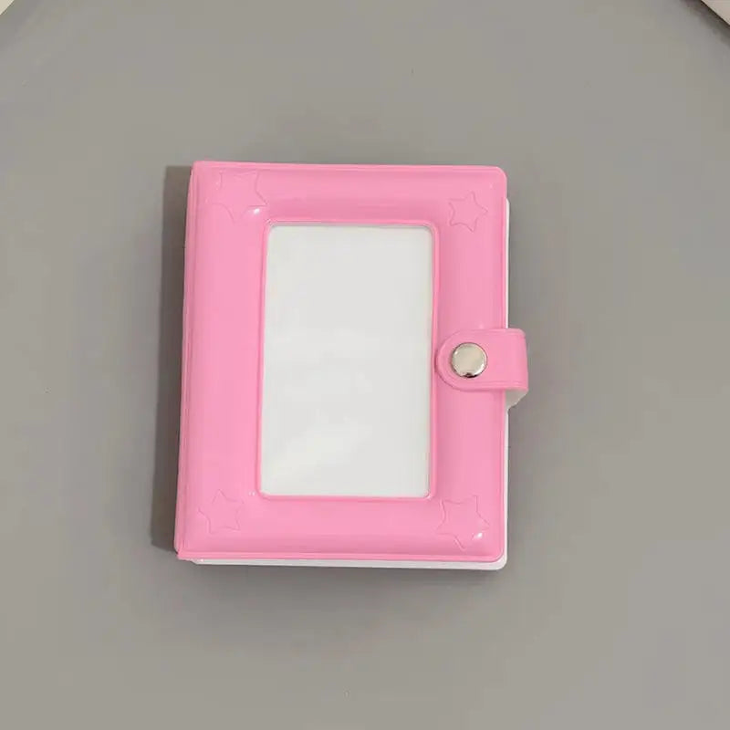 A pink mini photo card binder with a clear plastic cover and a silver clasp.