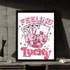 Pink typography art print featuring the words FEELING LUCKY with hearts and playing cards