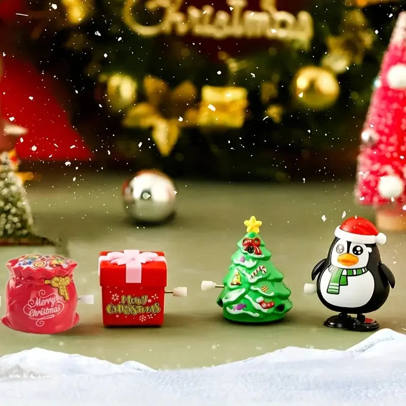 A festive display featuring clockwork wind-up figurines, including a red gift box, a green Christmas tree, and an owl decorat