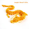 Golden flexible dragon figurine with textured scales shown against a white background.