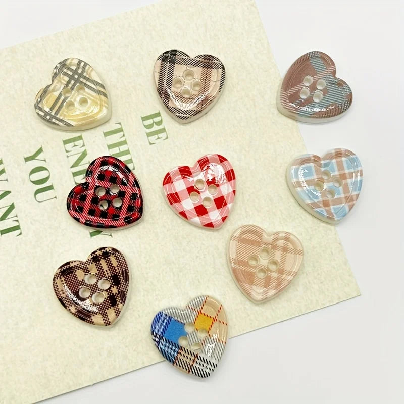 A collection of eight heart-shaped fridge magnets featuring various checkered patterns and colors.