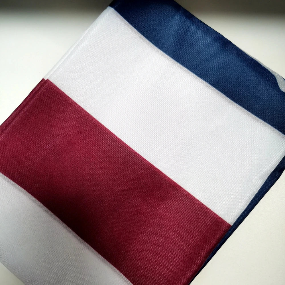 A decorative banner featuring vertical stripes of white, dark blue, and maroon fabric.