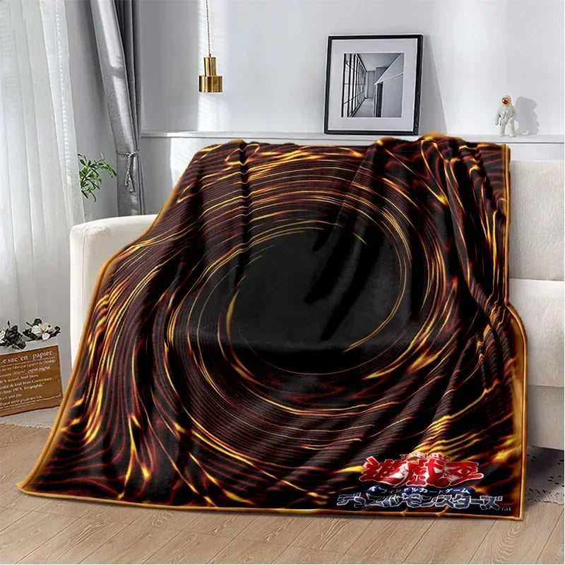 A dark, swirling pattern blanket featuring shades of brown and gold, suitable for a Yu-Gi-Oh! themed gift.