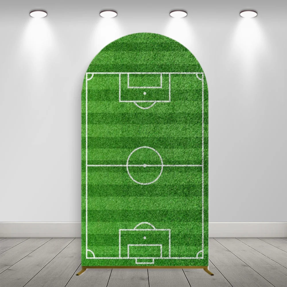 A green soccer field arch backdrop cover with white lines and a goal net mounted on a white wall.