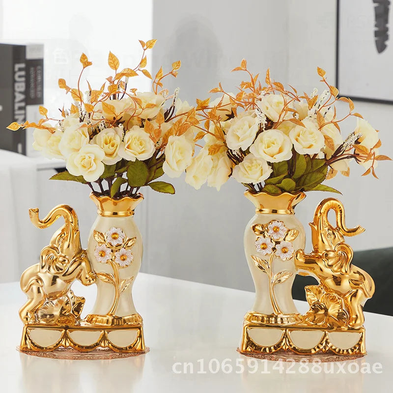 A pair of elegant ceramic vases shaped like swans with floral arrangements on a white surface.