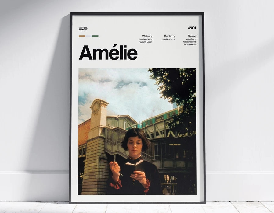 A framed poster featuring a black and white photo of a woman reading, titled Amélie.