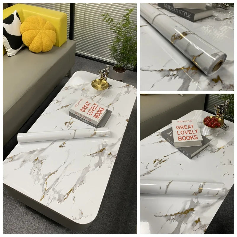 Rolls of marble contact paper with gold veining displayed on a white surface.