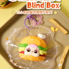 Samuel Blind Box featuring a cute yellow sandwich character in clear plastic packaging