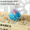 A vibrant blue and pink artificial succulent bonsai ball is displayed in a wooden box filled with small pebbles.