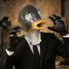 A person wearing a funny fish head latex costume mask and black suit jacket.