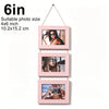 A set of three pink wooden photo frames with pictures of women and a person taking a photo, displayed on a string.