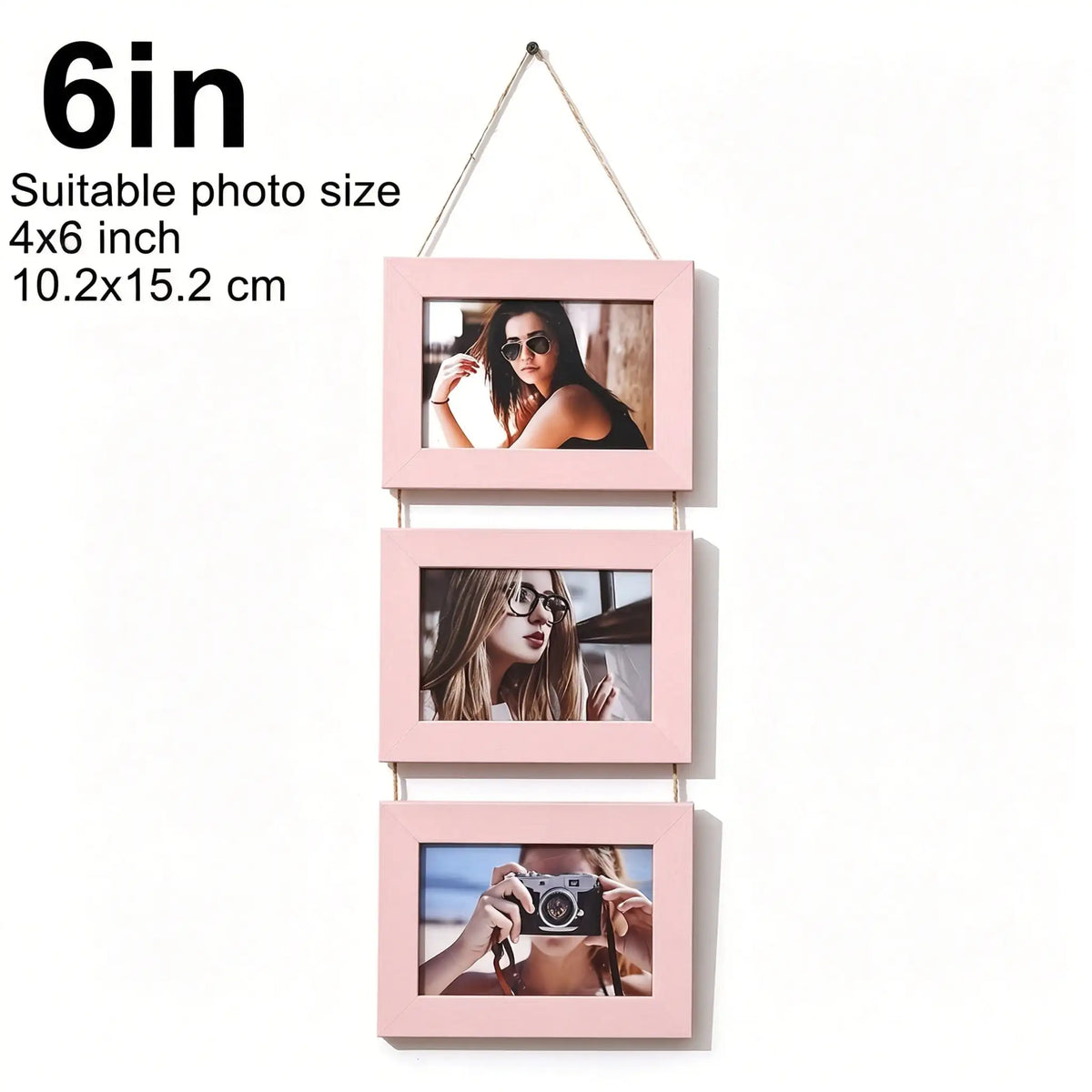 A set of three pink wooden photo frames with pictures of women and a person taking a photo, displayed on a string.
