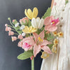 Handmade crochet flower bouquet featuring pink, yellow, and white peony, tulip, and rose flowers