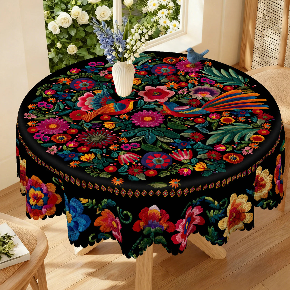 Vibrant Mexican style embroidered tablecloth featuring colorful floral and foliage patterns on a black fabric.