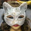 A close-up of an elegant white lace half-face mask worn by a model for cosplay or masquerade.