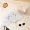 Bridal white feather hand fan with a rhinestone bride letter displayed on light fabric.