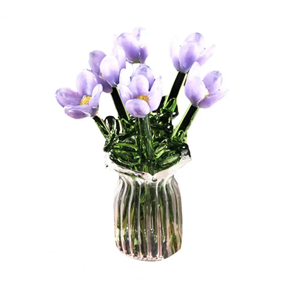 A bouquet of light purple hand-blown glass flowers in a clear glass vase.
