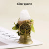 A clear quartz crystal is placed inside a natural brass bell with a copper finish.