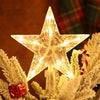 An LED glowing star topper decorated with white fluffy branches and a candy cane on a Christmas tree.