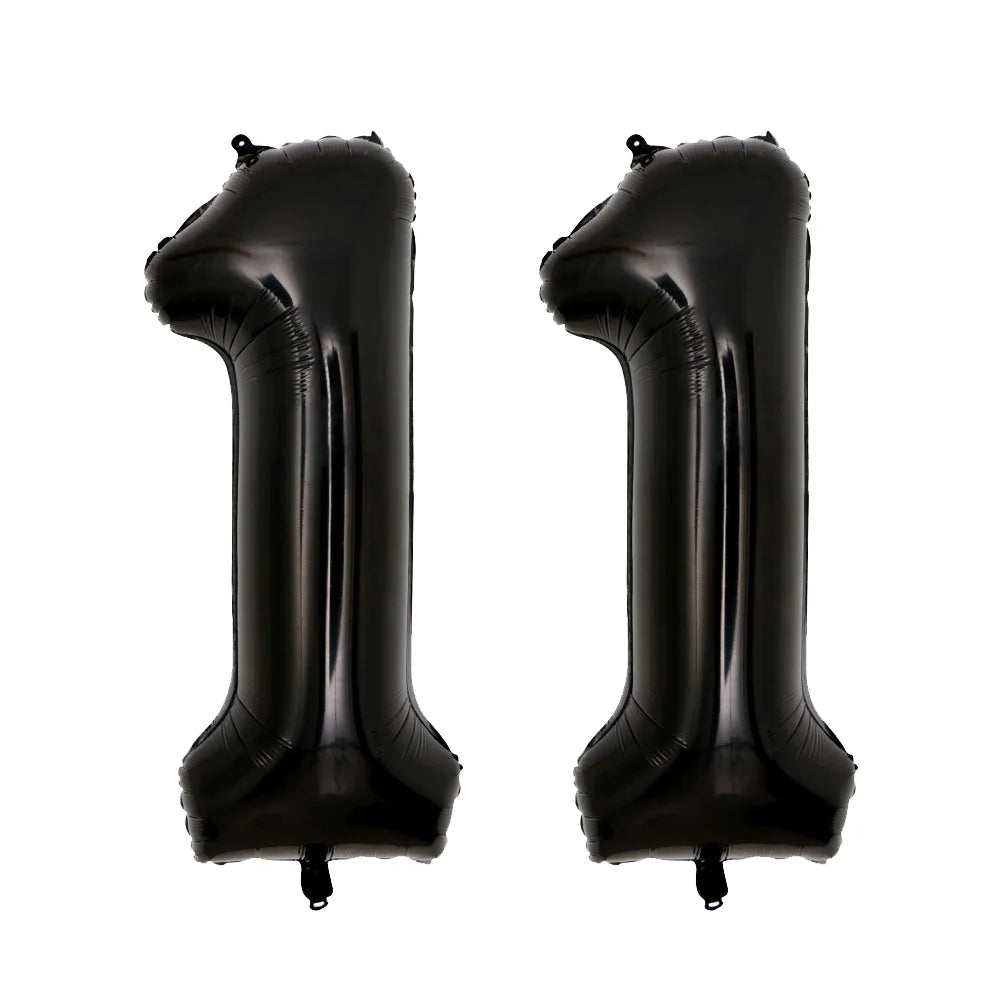 A pair of giant black foil balloons shaped like the number 1, shown against a white background.