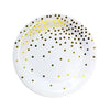A white plate decorated with gold and black polka dots.