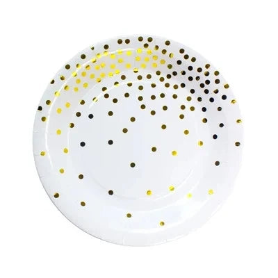 A white plate decorated with gold and black polka dots.