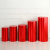 A row of four glossy red spandex cylinder stands displayed against a white paneled wall.