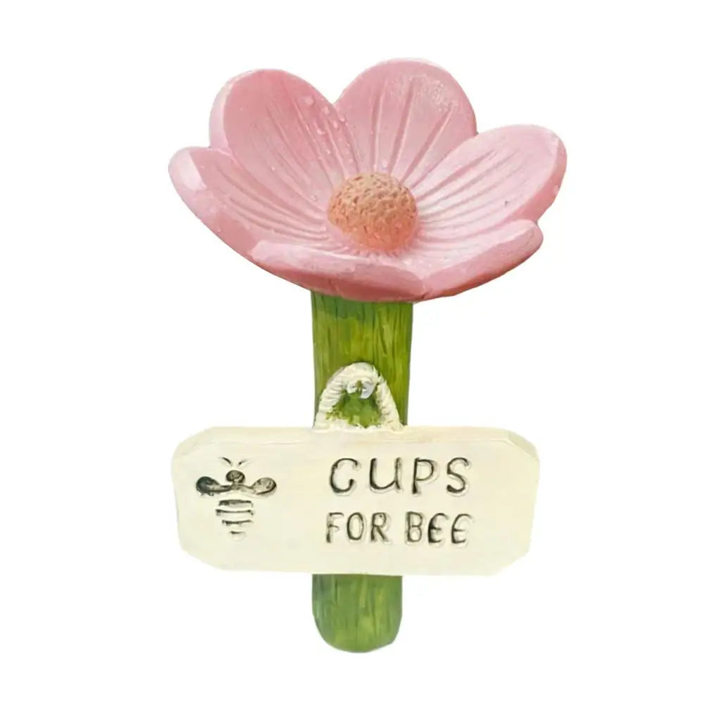 Pink flower shaped watering station with a bee tag for bees