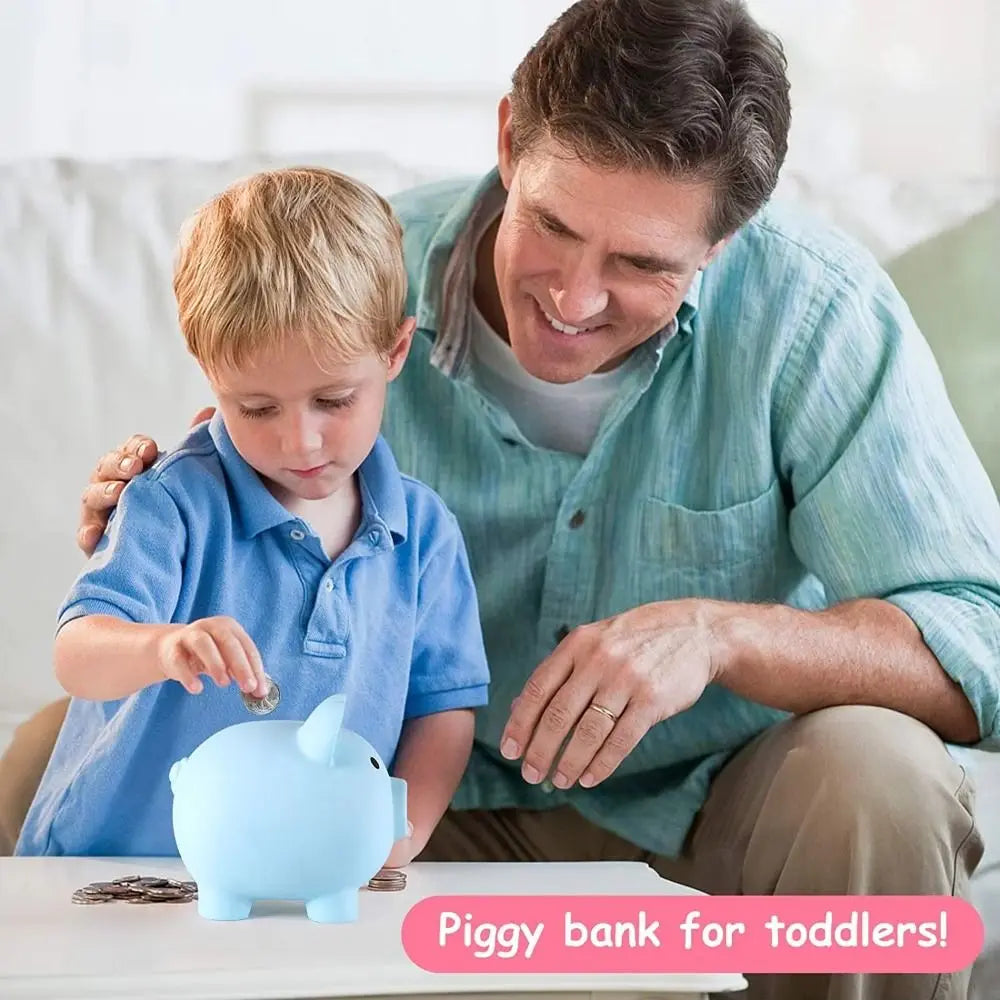A father is showing a toddler how to use a blue piggy bank for coin storage.