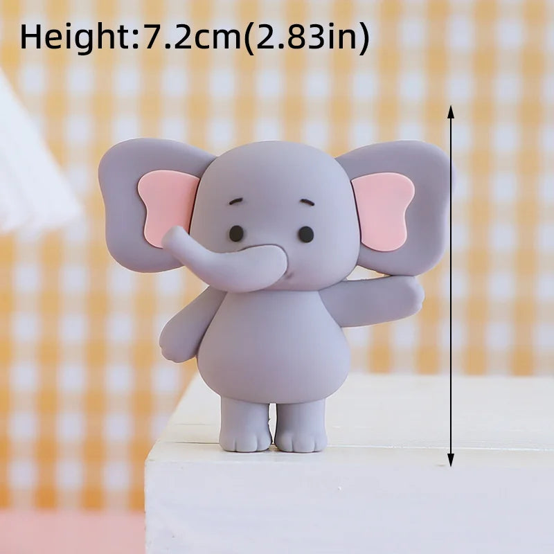 A small, light purple cartoon elephant figure with pink ears standing on a white surface.