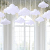 White cloud felt hanging decorations suspended in a window frame
