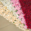 A close-up of an artificial cherry blossom privacy fence screen featuring a gradient of pink, white, and deep red flowers.