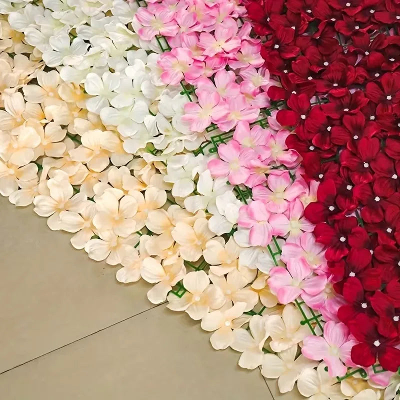 A close-up of an artificial cherry blossom privacy fence screen featuring a gradient of pink, white, and deep red flowers.