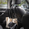 Four black leather headrest hooks with fabric bags are visible inside a car seat.