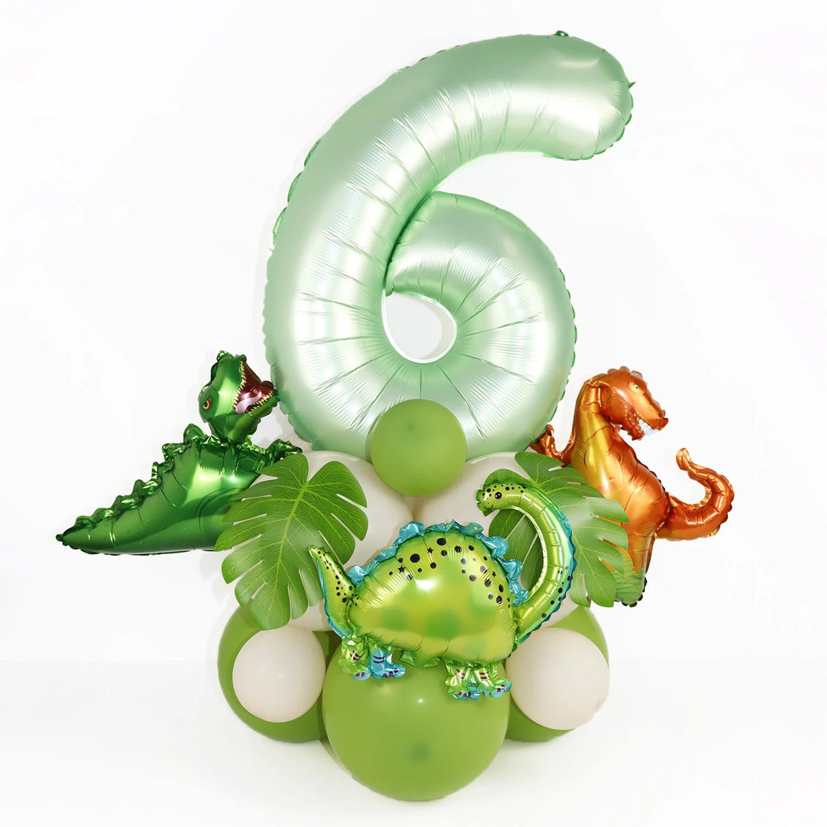 A set of avocado green foil balloons shaped like the number 6 and a dinosaur for birthday decoration