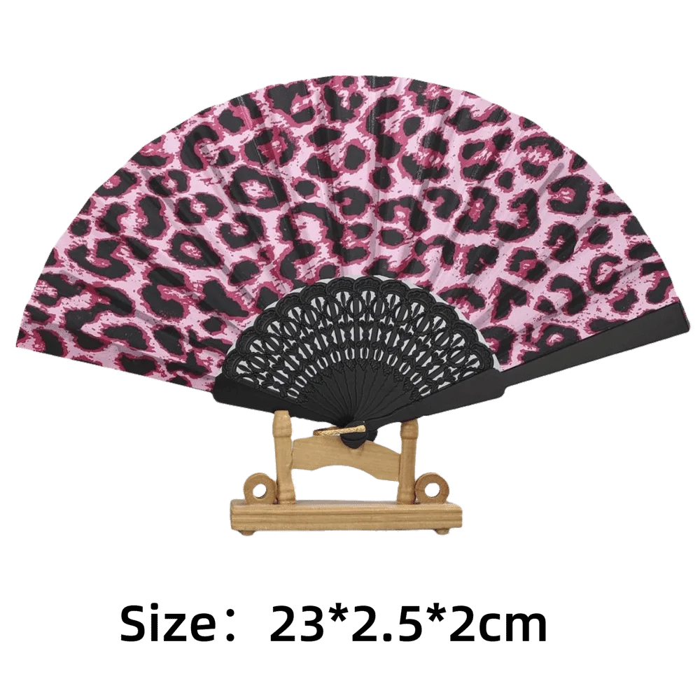 A folding hand fan featuring a leopard print design on the fabric and a black handle.