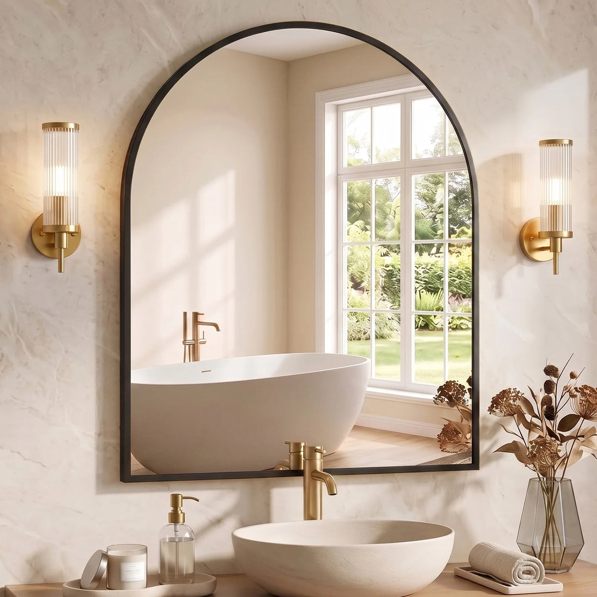 A modern bathroom featuring an arched mirror above a white vessel sink and faucet, set against a light beige wall.