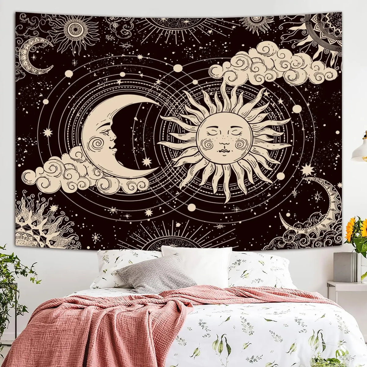 A dark tapestry wall hanging featuring a celestial design with crescent moons, suns, and clouds in gold and white tones.
