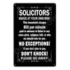 A black metal wall sign with text warning solicitors to knock at their own risk and charging $50 per minute.